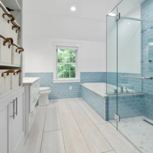 White bathroom with light blue accent tiles.