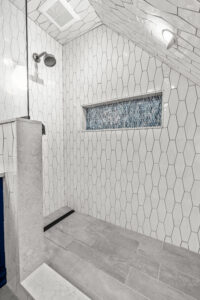 A mix of bold tiles in a large walk-in shower