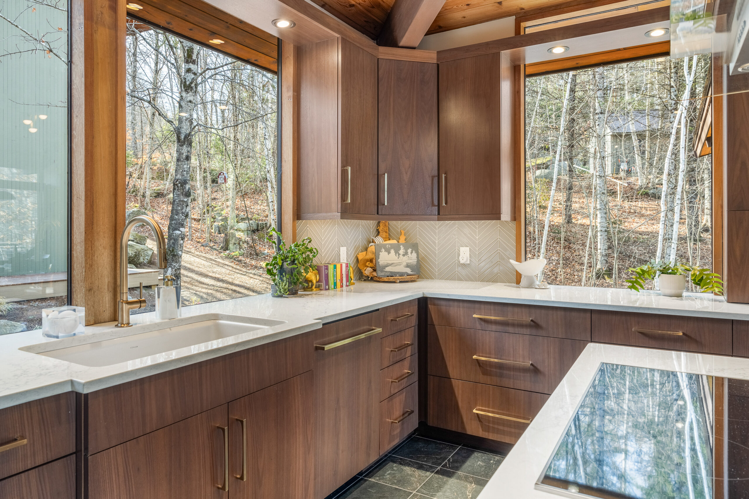 NH kitchen with dark wood cabinets and large square windows