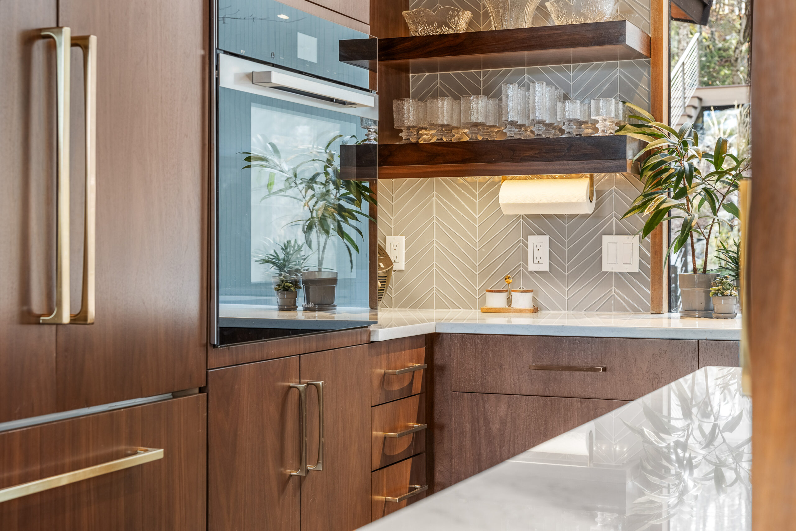 Grantham kitchen with dark wood, chevron backsplash and gold finishes