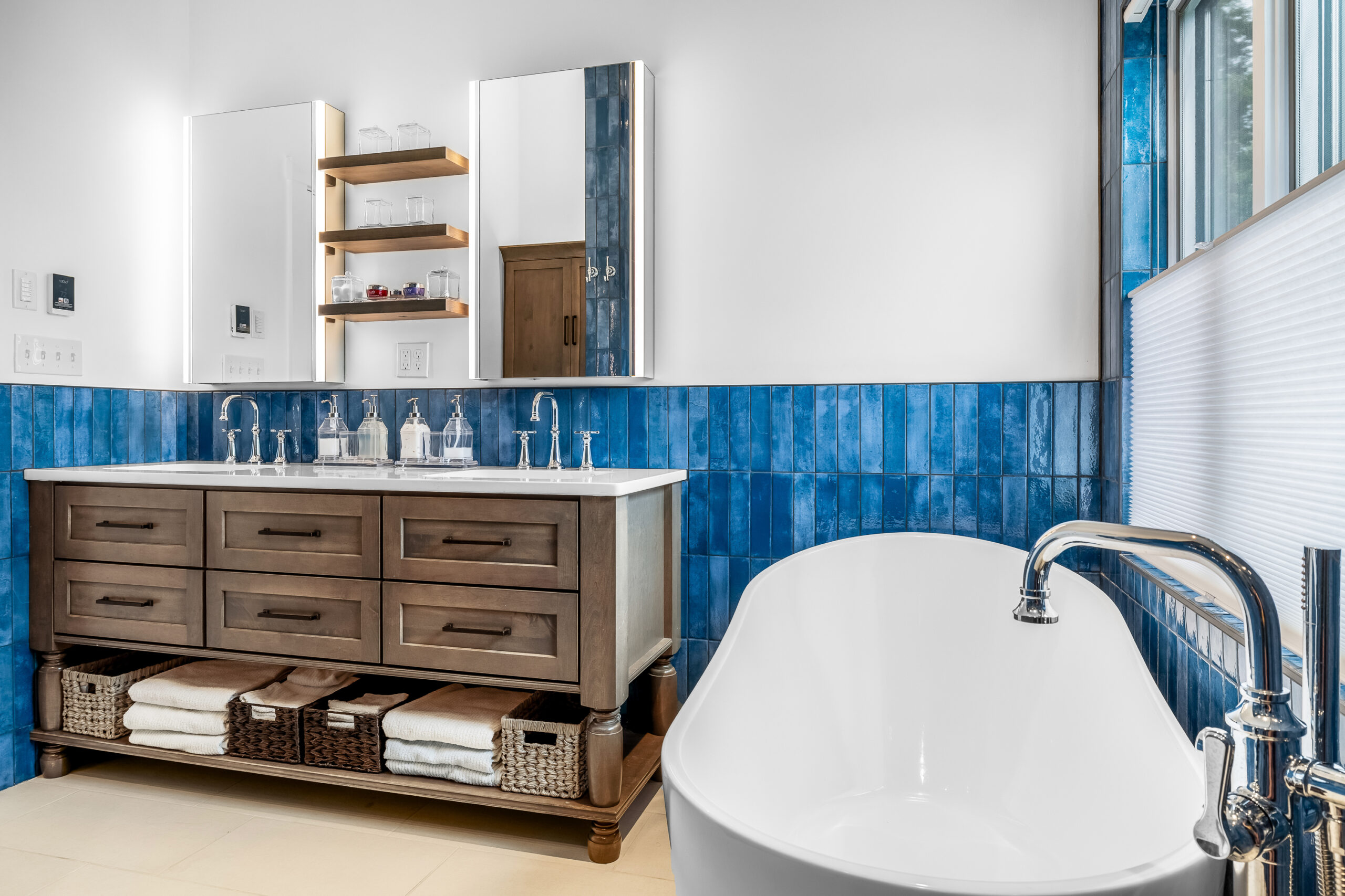 New Long bathroom renovation with blue tiled walls, vanity and soaker tub