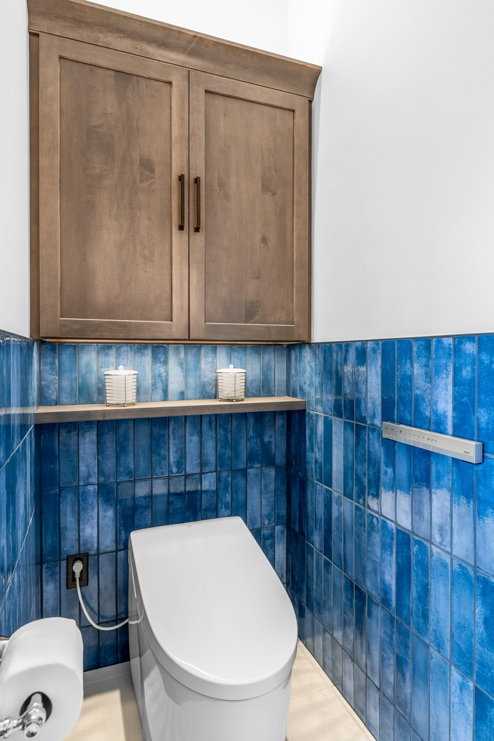 Bathroom reno with blue tile walls and toilet