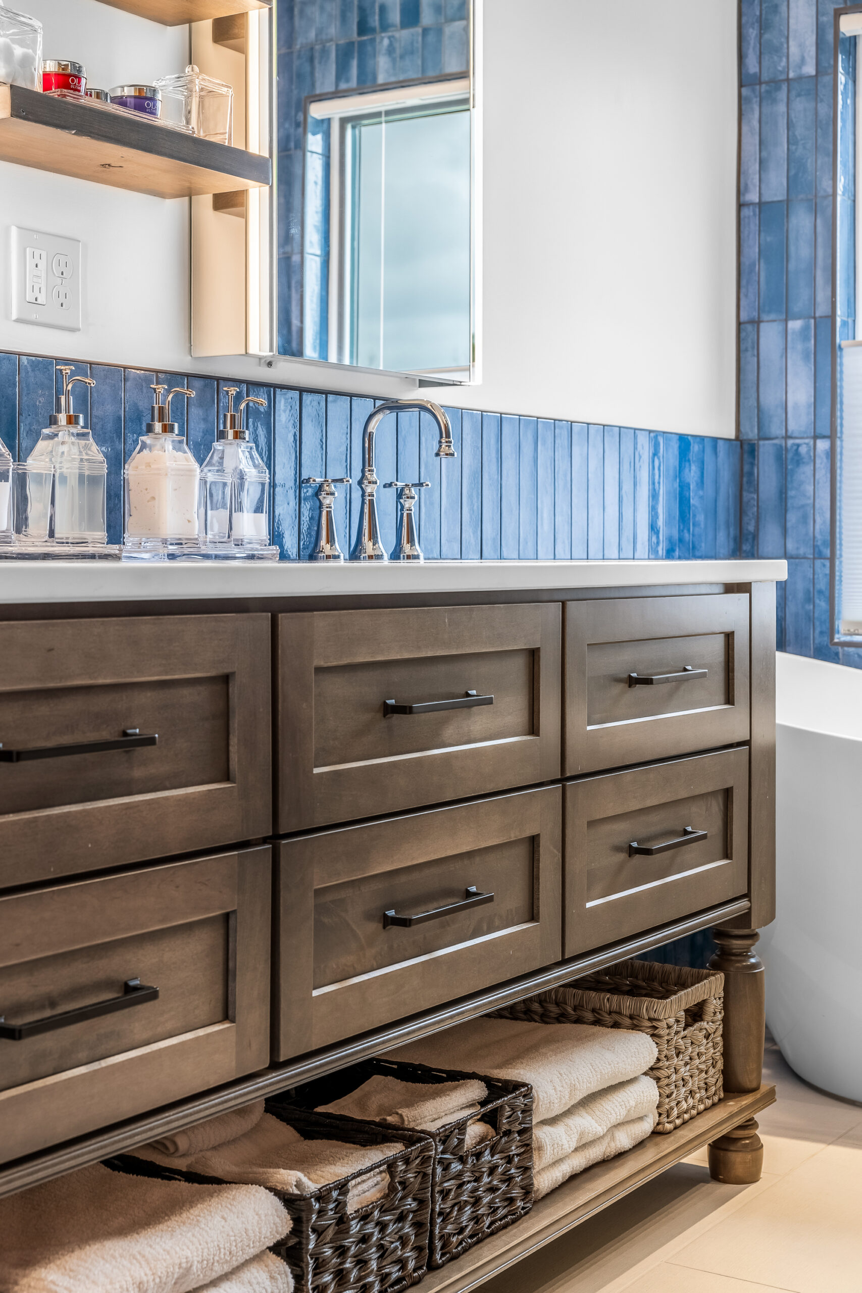 New London Bathroom Reno with wood vanity with black handles and white countertop