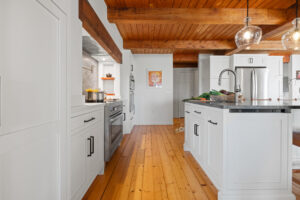 hanover remodeled kitchen with white cabinets and a wood floor and wood ceiling