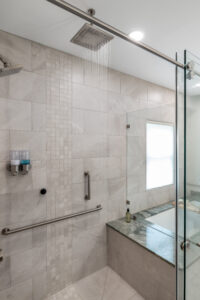 curbless glass wall shower with bench and rainhead
